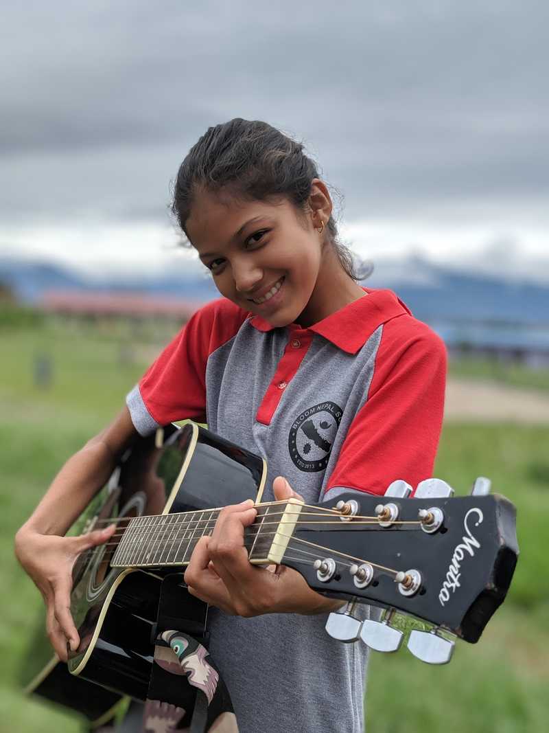 A female student playing guitar